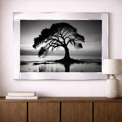 Mirrored tree stands by the lake, illuminated under the night sky